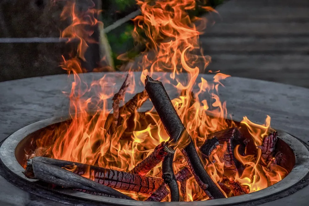 Camp fire pit burning at dusk
