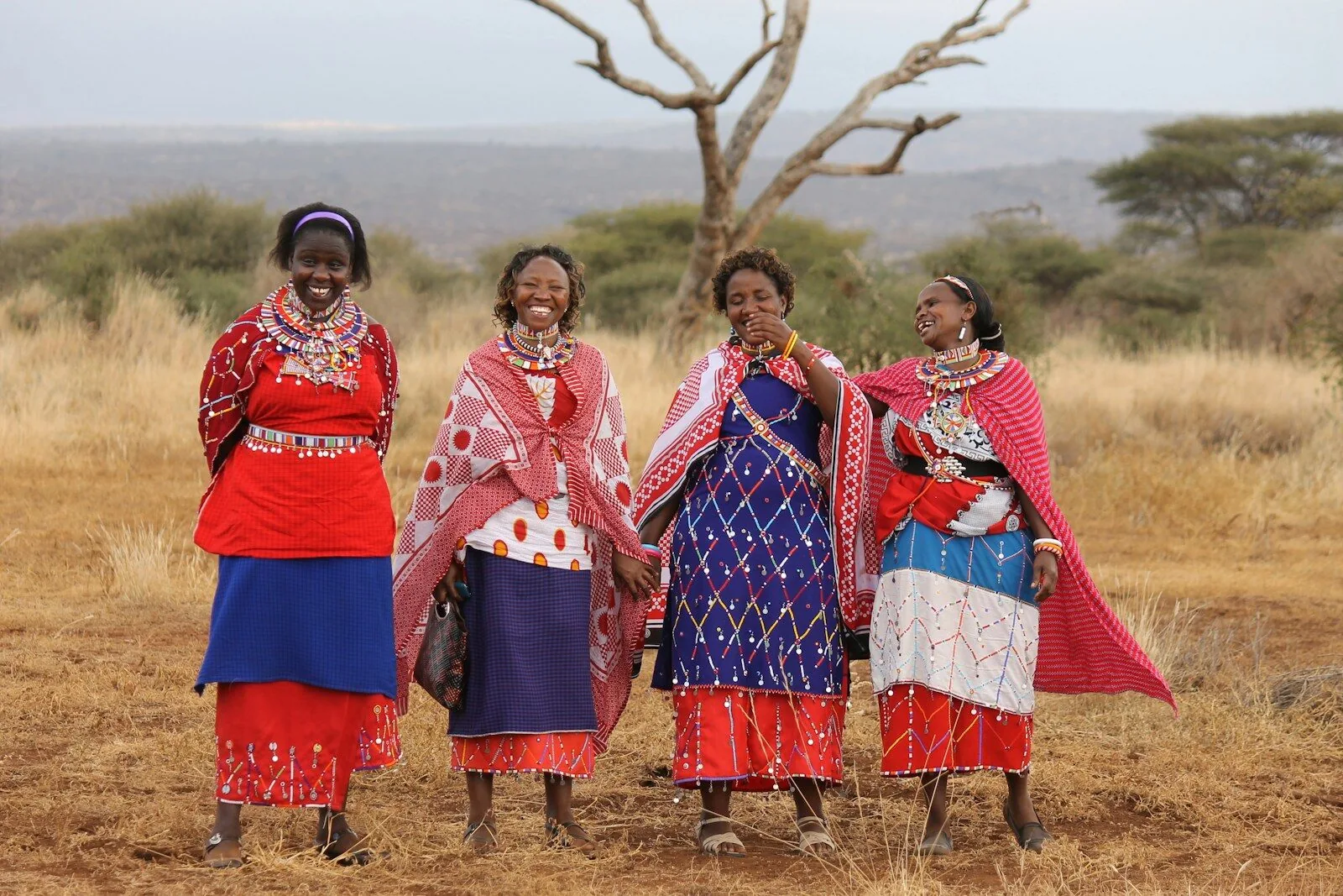 A group of women standing together in a field